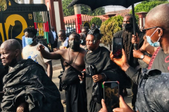 Nana Owusu Korkor II with rifle and headgear at coronation festivities (procession)