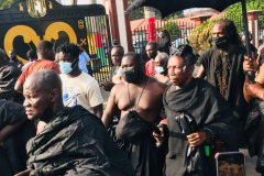 Nana Owusu Korkor II with rifle and headgear at coronation festivities (procession)