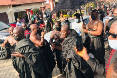 Nana Owusu Korkor II with rifle and headgear at coronation festivities (procession)