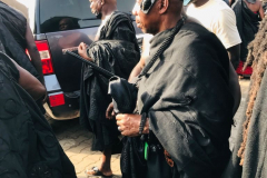 Nana Owusu Korkor II with rifle and headgear at coronation festivities (procession)