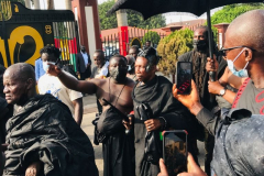 Nana Owusu Korkor II with rifle and headgear at coronation festivities (procession)