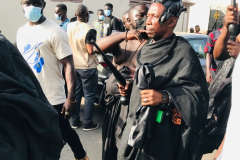 Nana Owusu Korkor II with rifle and headgear at coronation festivities (procession)