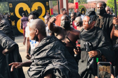 Nana Owusu Korkor II with rifle and headgear at coronation festivities (procession)