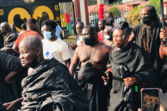 Nana Owusu Korkor II with rifle and headgear at coronation festivities (procession)