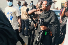 Nana Owusu Korkor II with rifle and headgear at coronation festivities (procession)