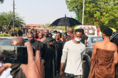 Nana Owusu Korkor II with rifle and headgear at coronation festivities (procession)