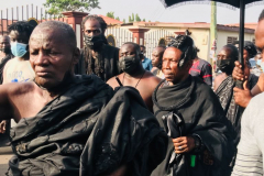 Nana Owusu Korkor II with rifle and headgear at coronation festivities (procession)