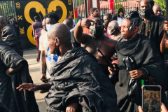 Nana Owusu Korkor II with rifle and headgear at coronation festivities (procession)